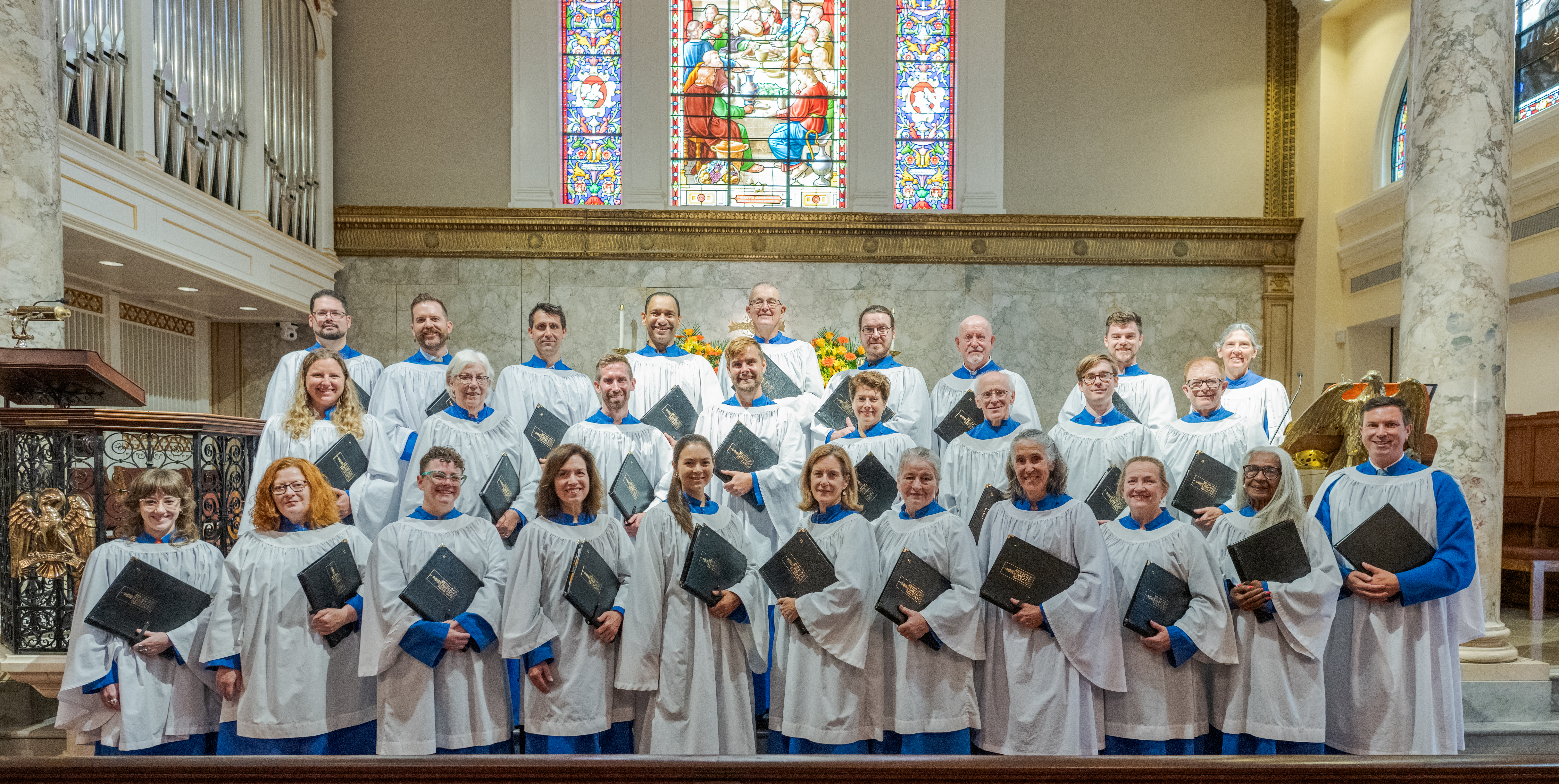 Formal group photo of the 27 adult members of the parish choir, along with the Director of Music Brent Erstad